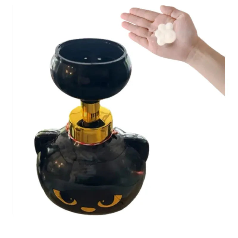 Black cartoon cat-shaped plastic foam soap dispenser on a wash basin.