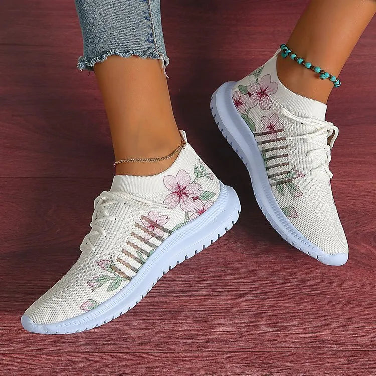 Women's Milky White mesh flyknit running shoes with round toe and rubber sole on a flat surface.