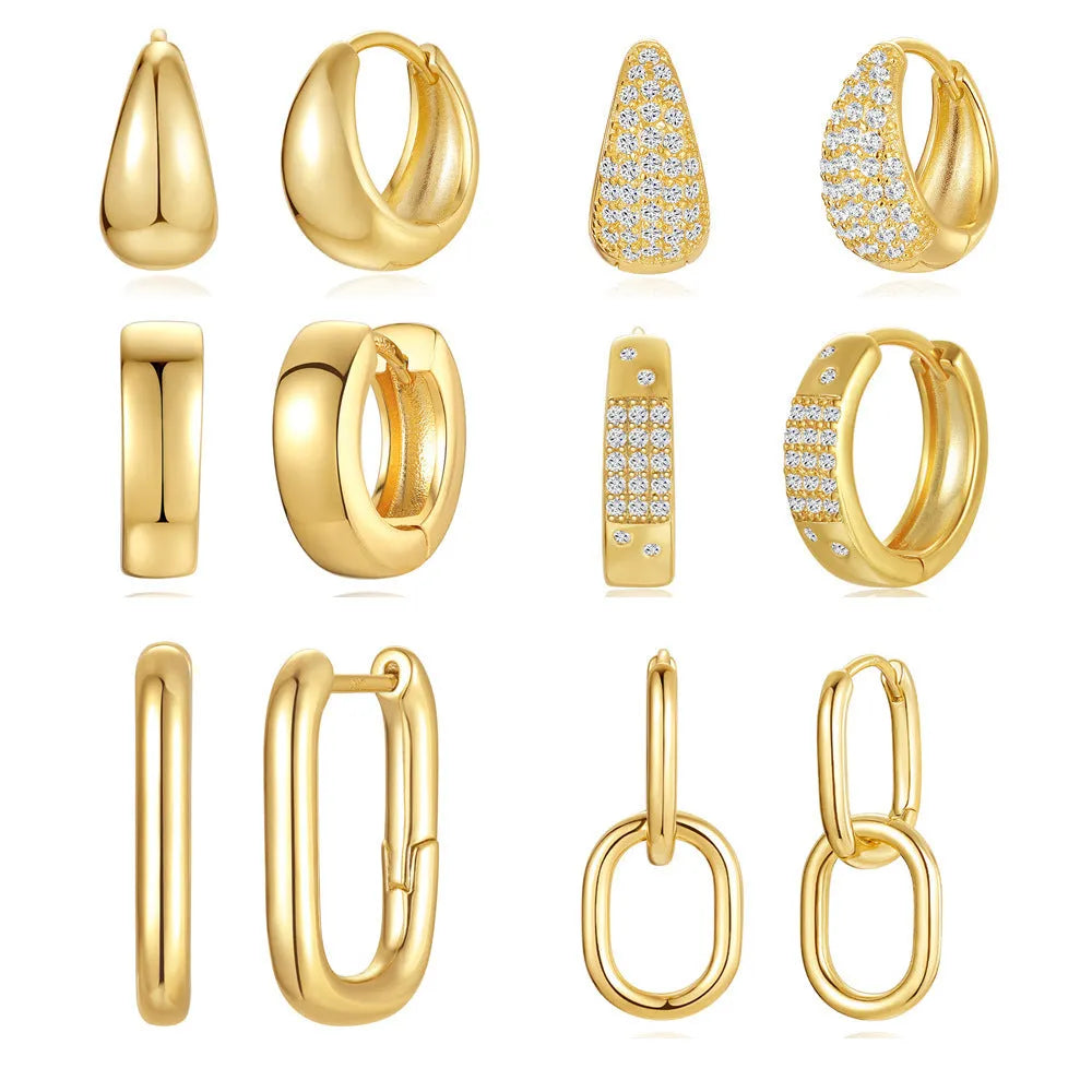 A pair of round, gold-toned brass diamond earclip earrings on a white background.