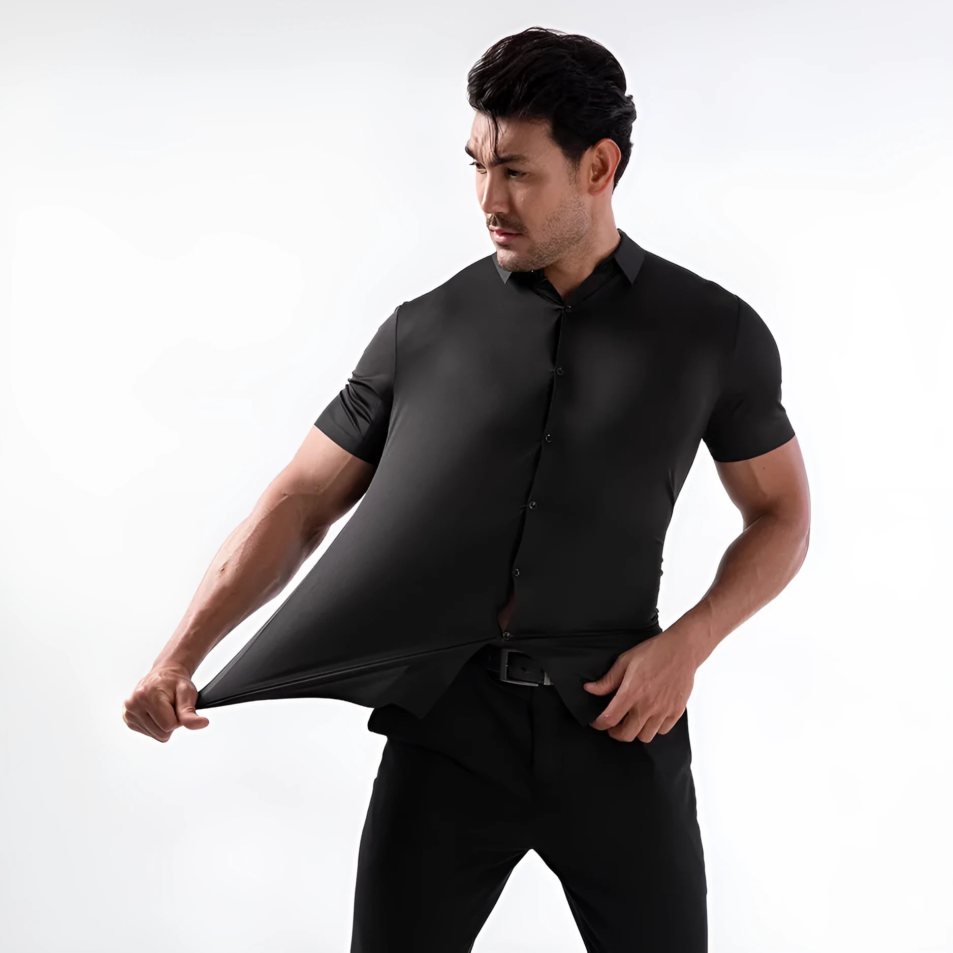 Man wearing a grey short sleeve cardigan-style shirt made from elastic non-iron fabric.