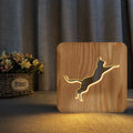 Solid wood cat-shaped night light with 3D hollow design and USB cable.