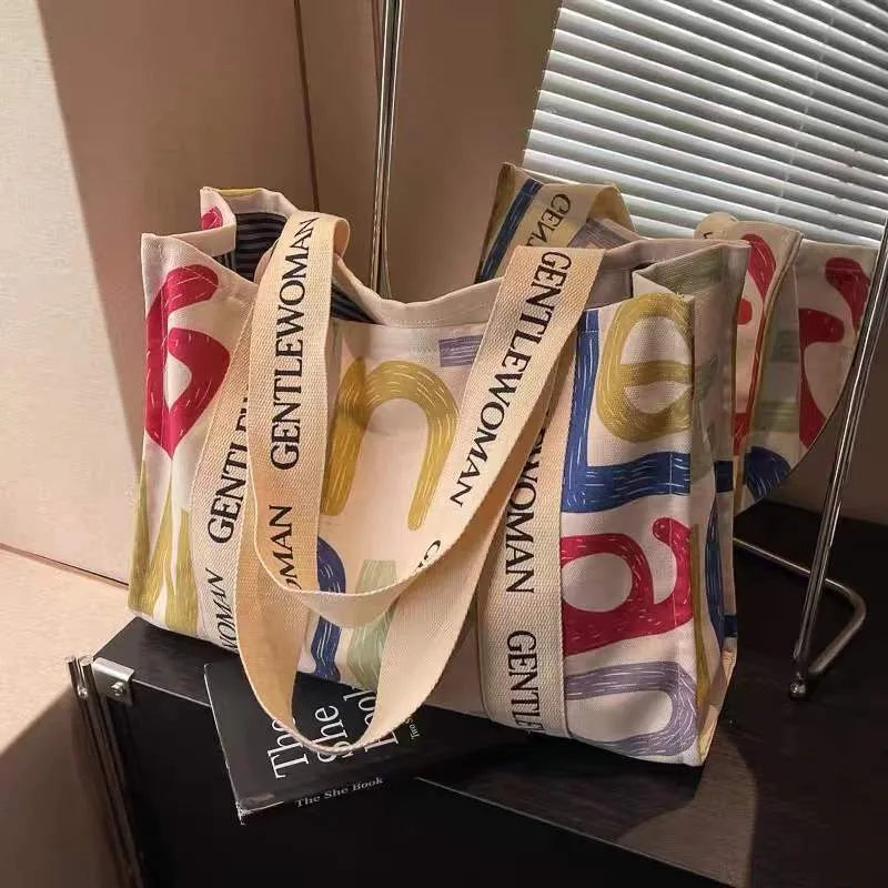 Large canvas tote bag with printed design, showing substantial capacity and casual styling