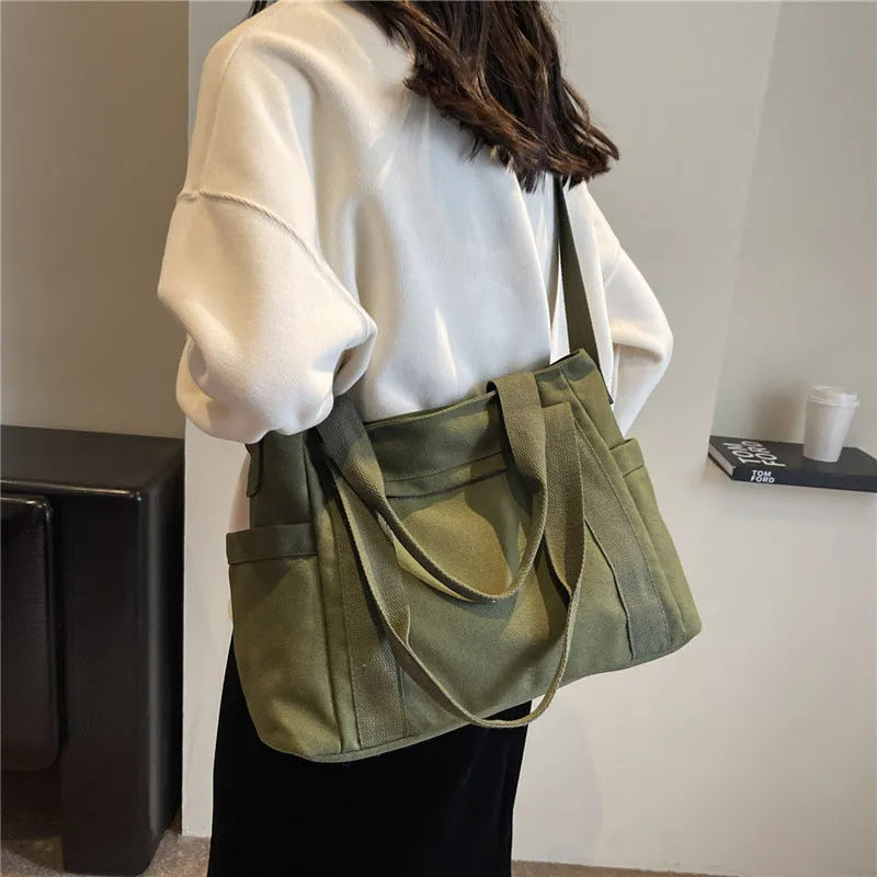 Large canvas shoulder tote bag in solid colour with sandwich pocket organisation