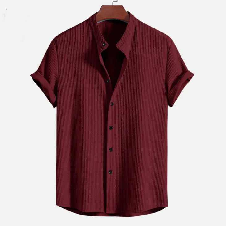 Man wearing a loose fit short sleeve polyester summer shirt in a light blue colour.