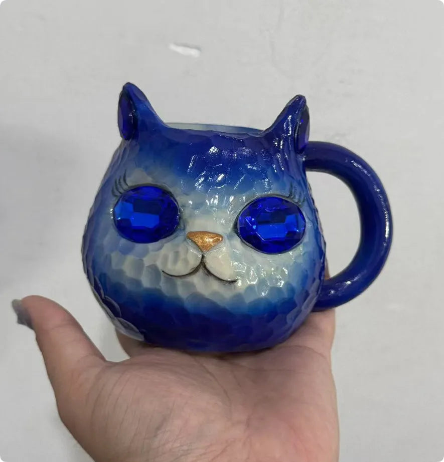Crystal Earth globe decorative ornament on top of a colourful cat-shaped resin cup.