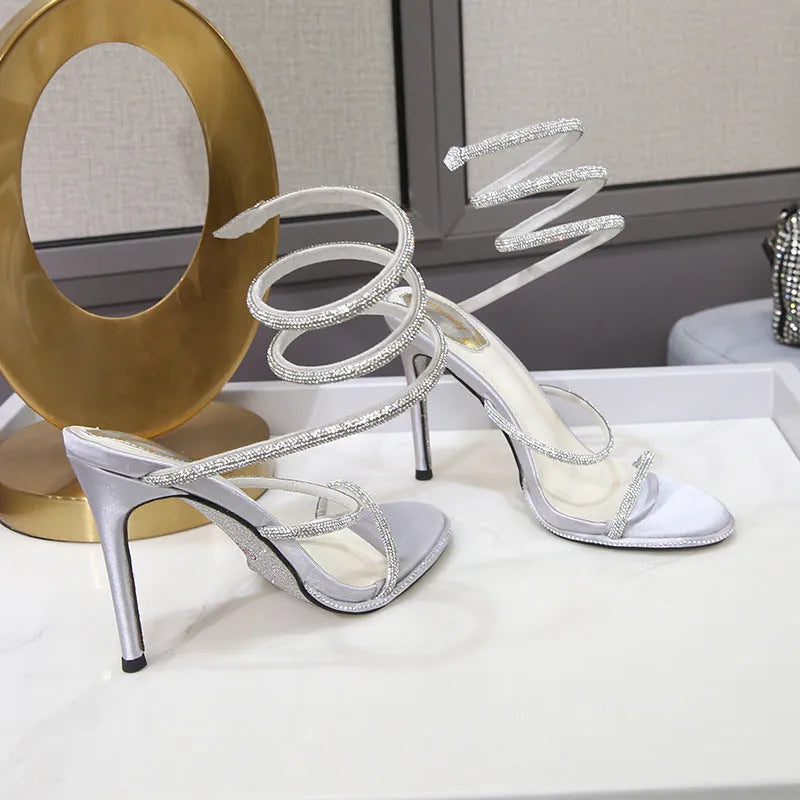 Women's rhinestone ankle-strap stiletto sandals with satin upper, round toe, and 10cm heel in silver colour