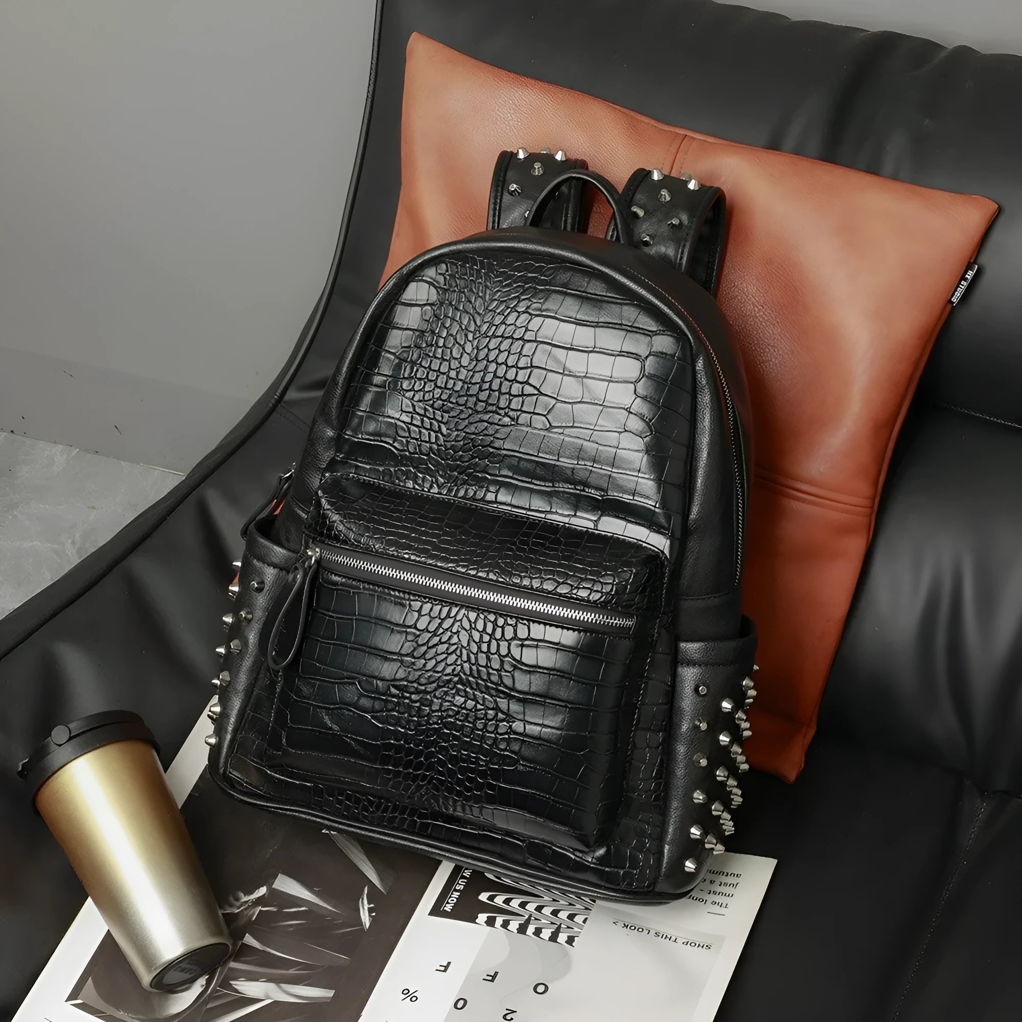 Black waterproof PU oil wax leather computer schoolbag with 36-55L capacity and rivet details.