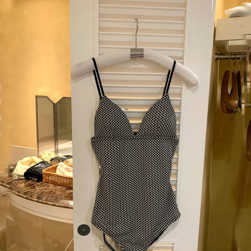 Blue V-neck one-piece swimsuit on a mannequin, designed for belly coverage and a smaller chest.