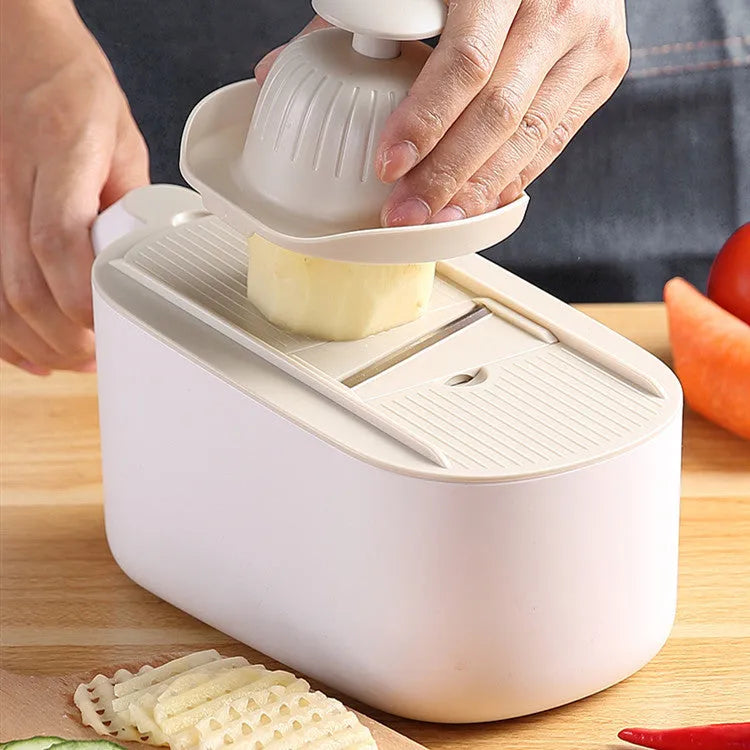 Nordic style multifunctional vegetable slicer in blue, grey, or khaki with stainless steel blades on a kitchen counter.