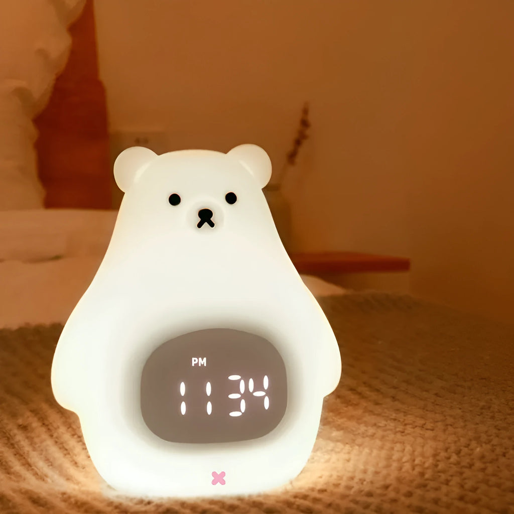 White bear-shaped silicone night light with a remote control and alarm clock features.