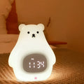 White bear-shaped silicone night light with a remote control and alarm clock features.