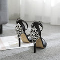 Black suede women's high heel sandals with fish mouth toe and rhinestone decoration on a rubber sole.