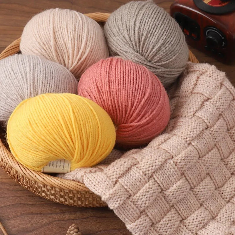 Roll of hand-knitting wool threads in various colours for baby garments with 10 knitting needles