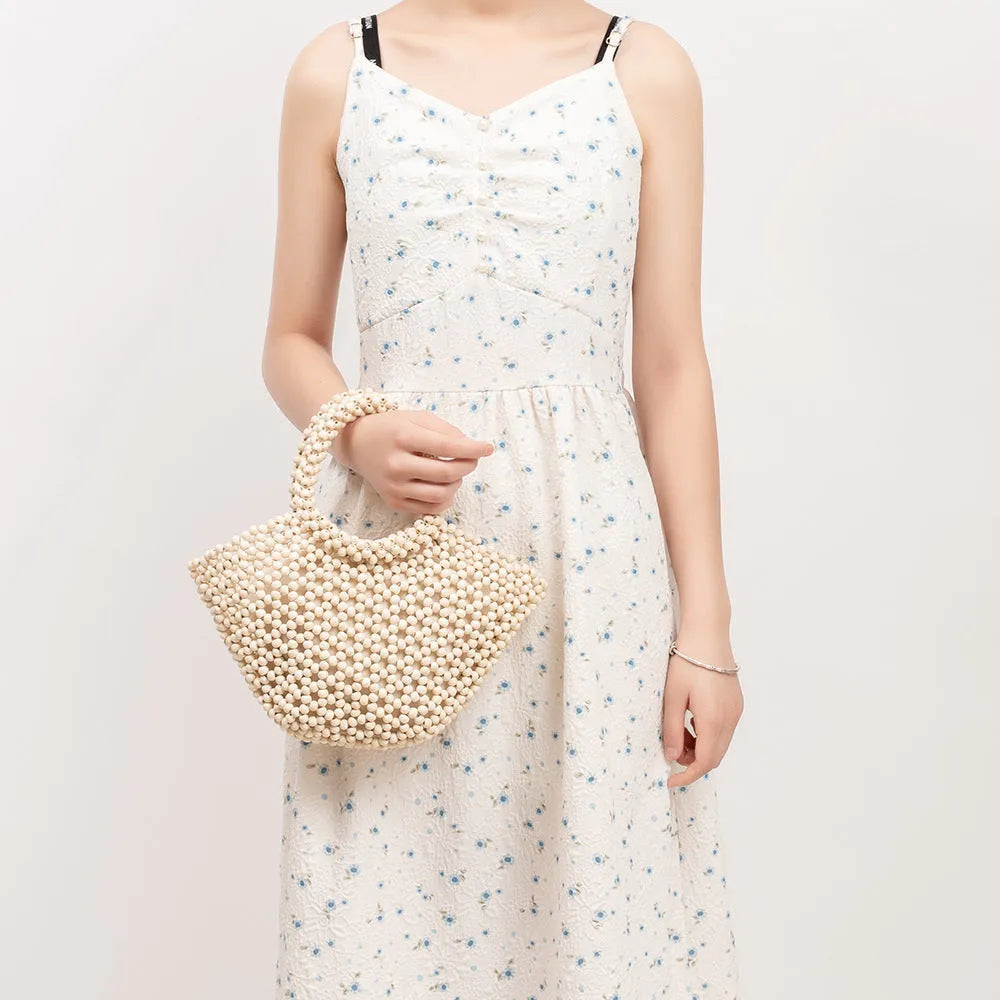 Hand-woven maple wood beach bag with wooden bead decoration in dumpling shape