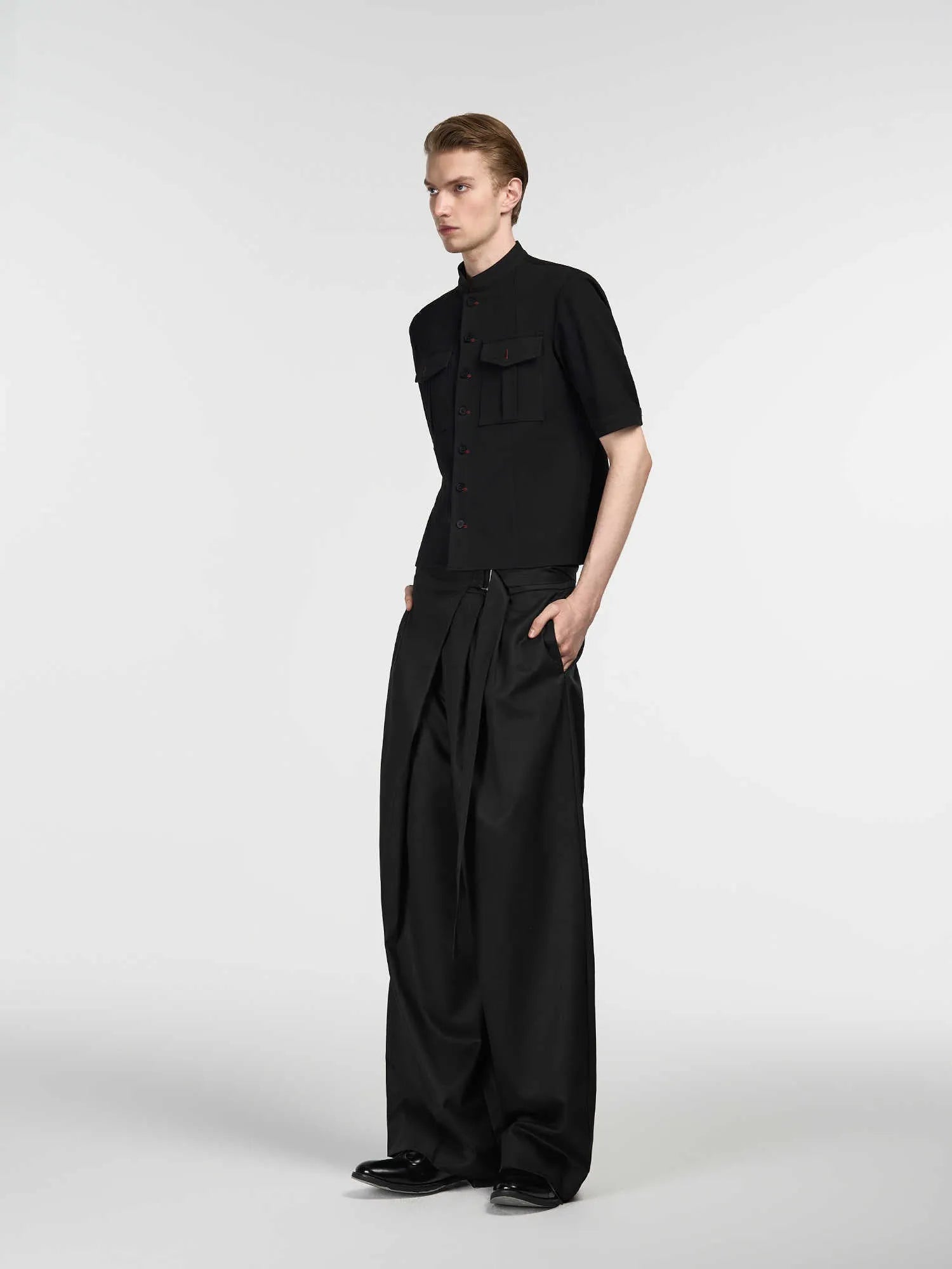 Black straight-leg trousers with adjustable waist and single pleat detailing