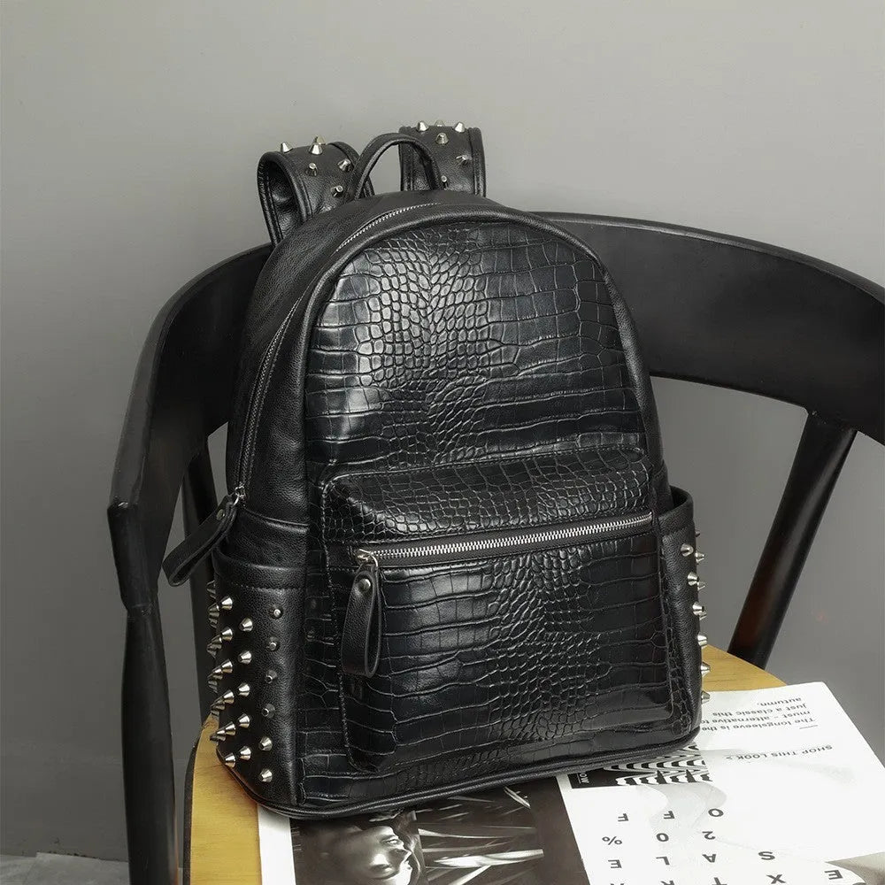Black waterproof PU oil wax leather computer schoolbag with 36-55L capacity and rivet details.