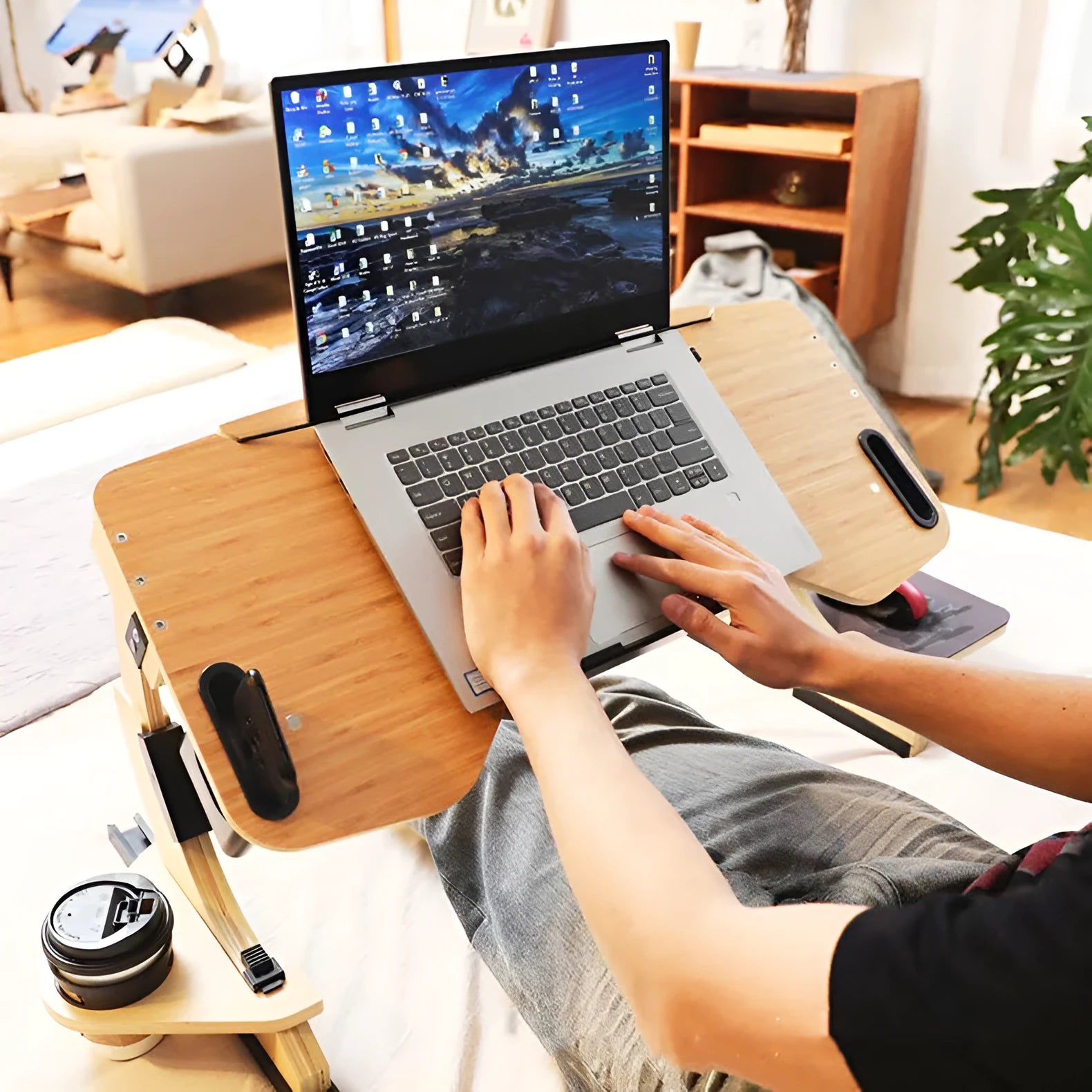 White wooden folding laptop bed table with adjustable angle, shown on a bed.