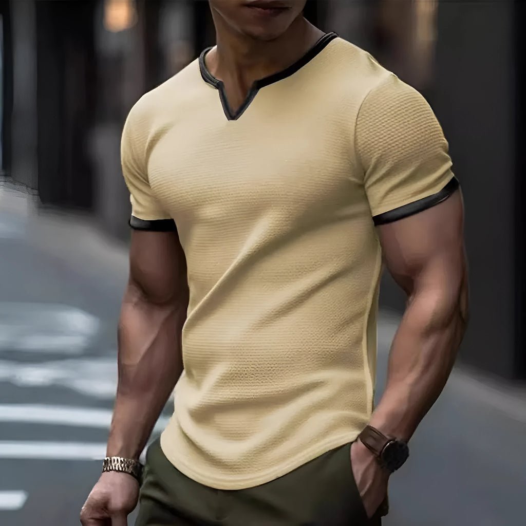 Man wearing a grey and white colour-block V-neck waffle knit short sleeve T-shirt.