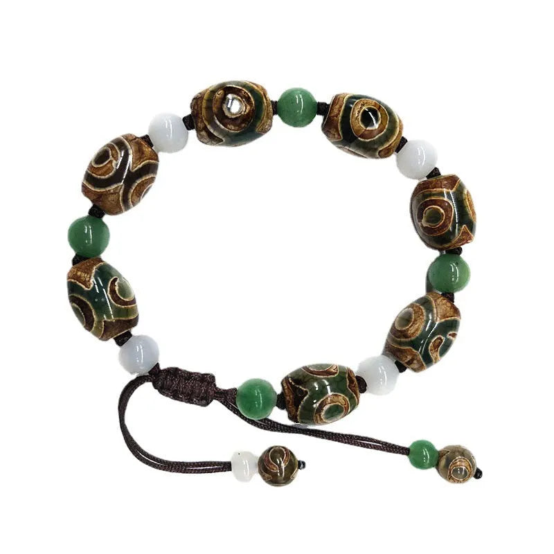 Green agate ethnic bracelet with hand-woven beads showing geometric patterns and three-eye design details
