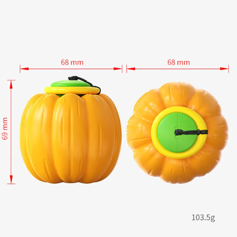 Orange plastic pumpkin-shaped dog chew toy with squeaker on a green background
