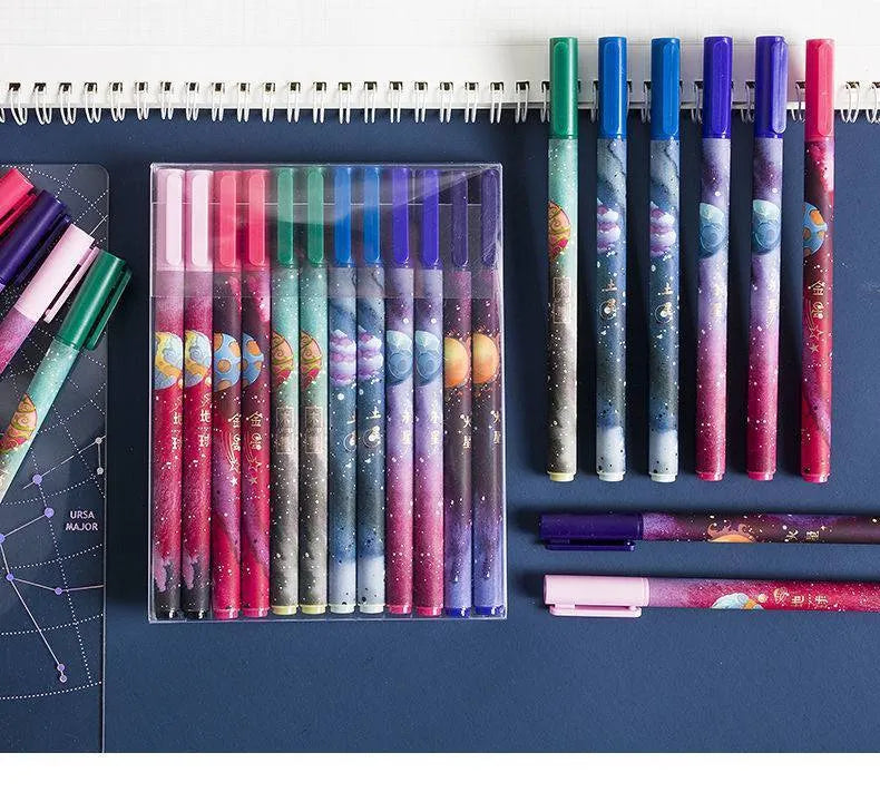 Twelve zodiac constellation ballpoint pens in assorted colours with plastic barrels and star motifs