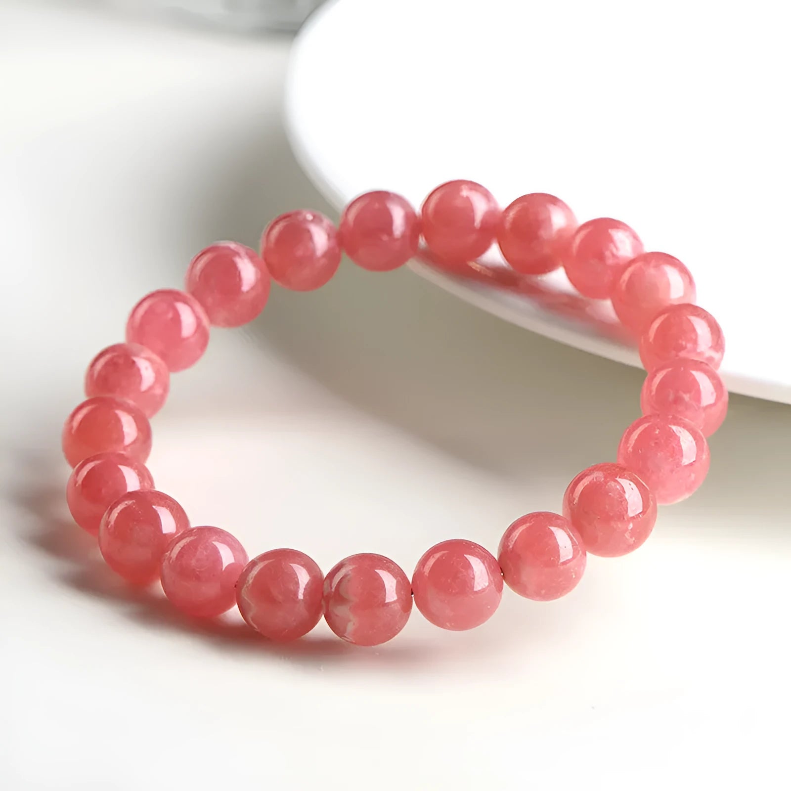 Geometric red crystal women's bracelet with a longevity lock fastening on a wrist.