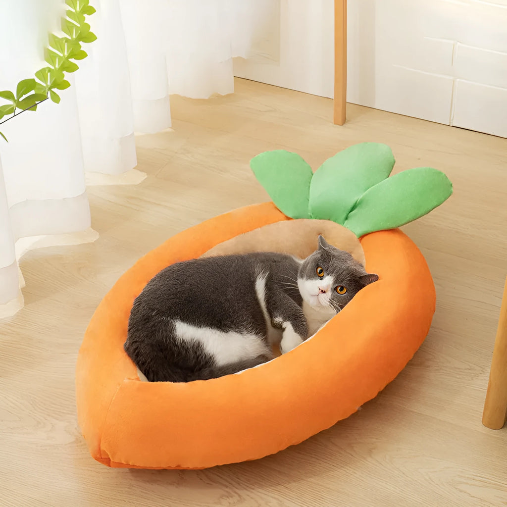 Carrot-shaped nesting dog bed with a soft blanket for small to medium-sized dogs.