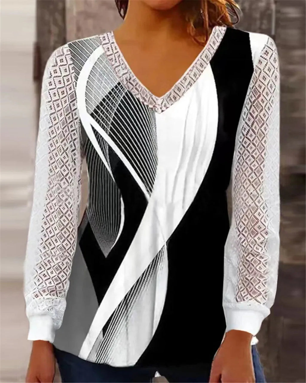 Women's loose purple V-neck top with hollow-out lace print detail and long sleeves.