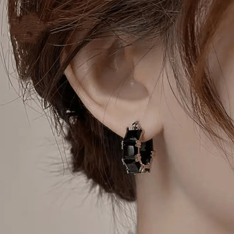 Women's geometric U-shaped earrings with round black zirconium stones and gold electroplated copper construction