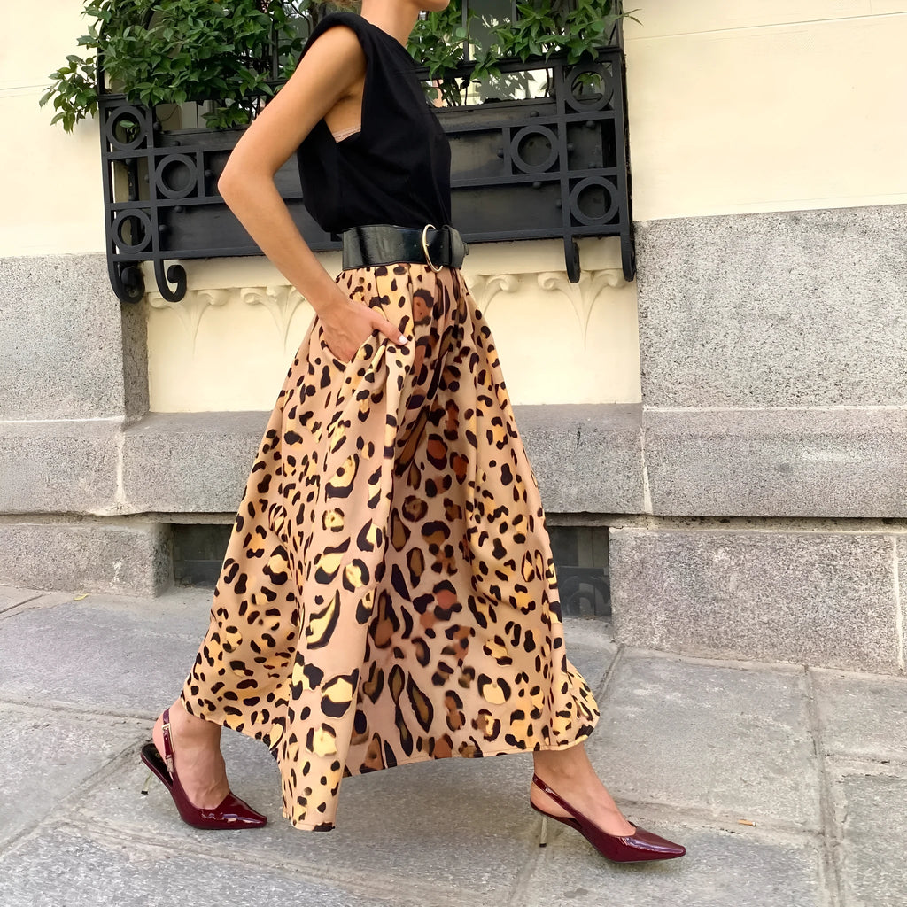 Brown leopard print women's long A-line skirt with a big hem detail on a hanger.