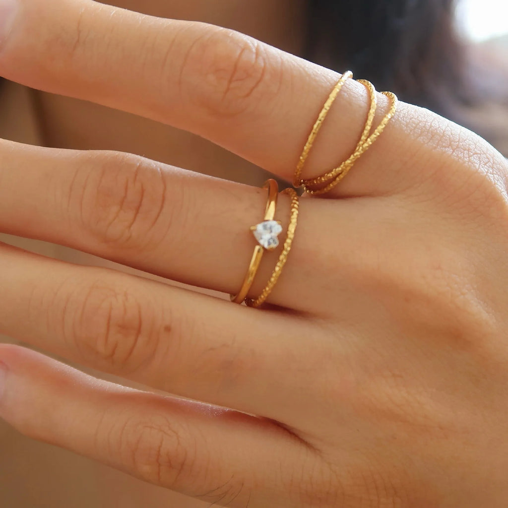 Golden love heart stainless steel ring for women on a simple band, shown in sizes no.5 to no.8
