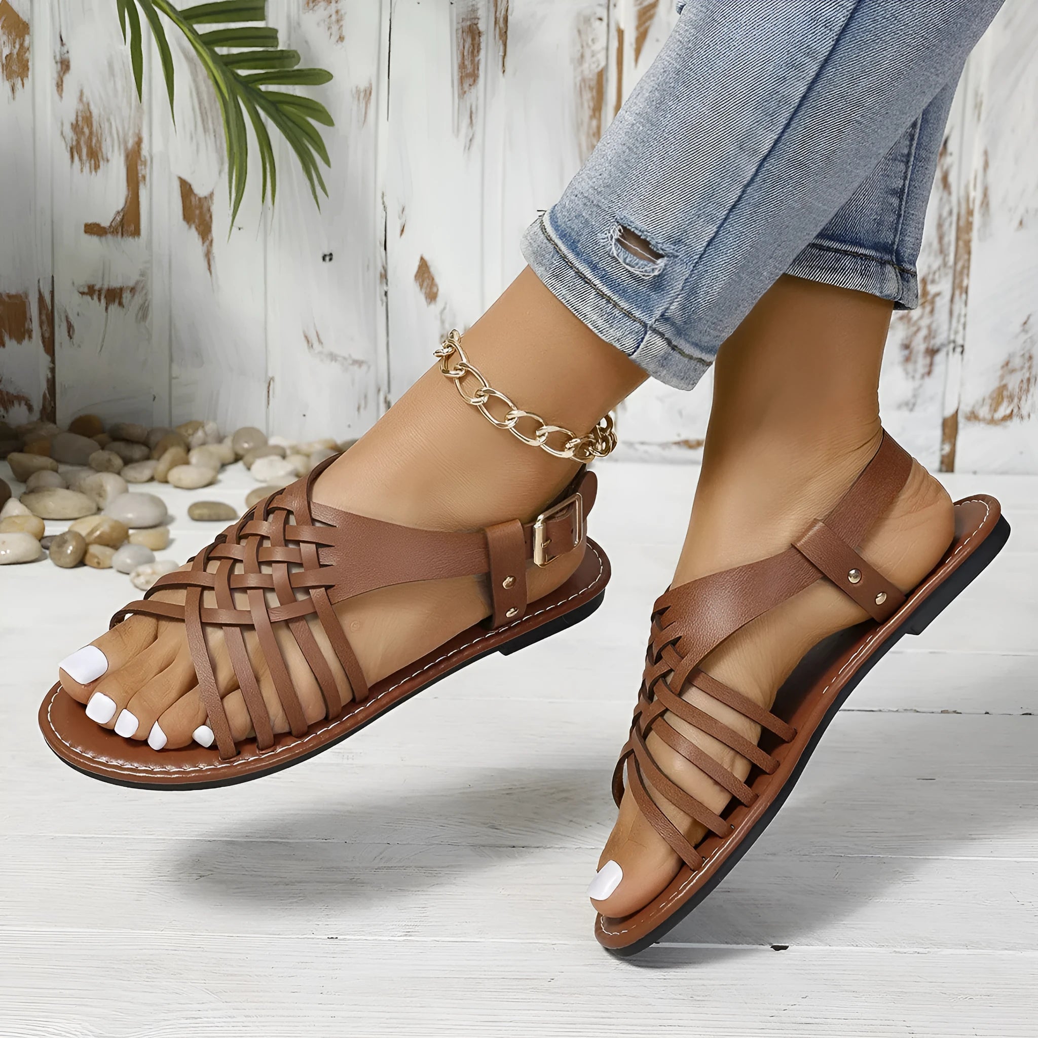 Flat buckle open toe Roman style beach slippers in black with cross straps and hollow out sole