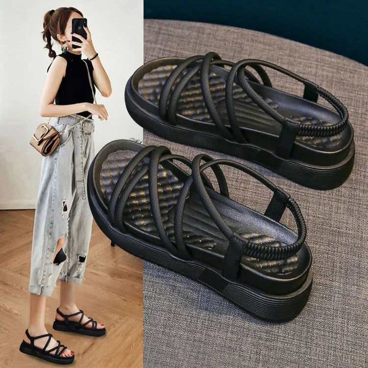 Women's black and beige Roman-style platform sandals with round toe and slip-on design.