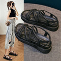 Women's black and beige Roman-style platform sandals with round toe and slip-on design.