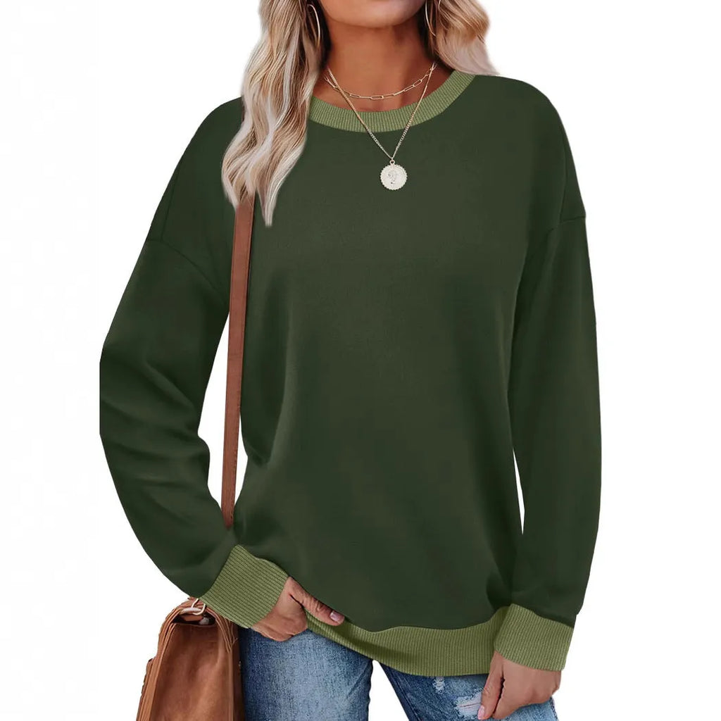 Woman wearing a loose-fitting, long-sleeved striped top with a round neckline in a choice of seven colours.