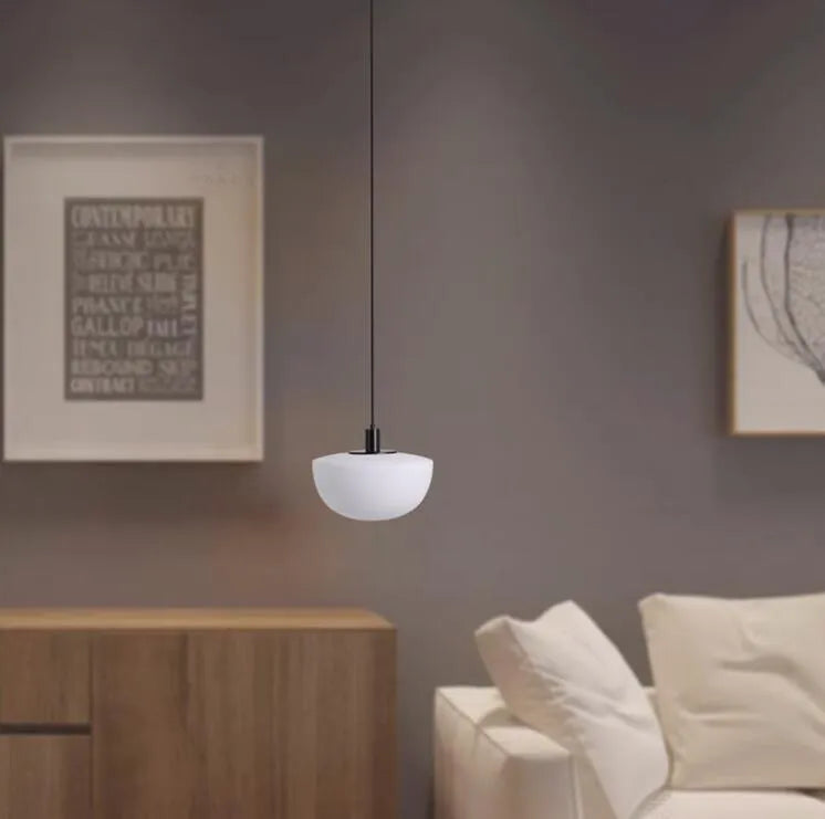 Simple modern milky white glass single-head pendant light suspended from ceiling