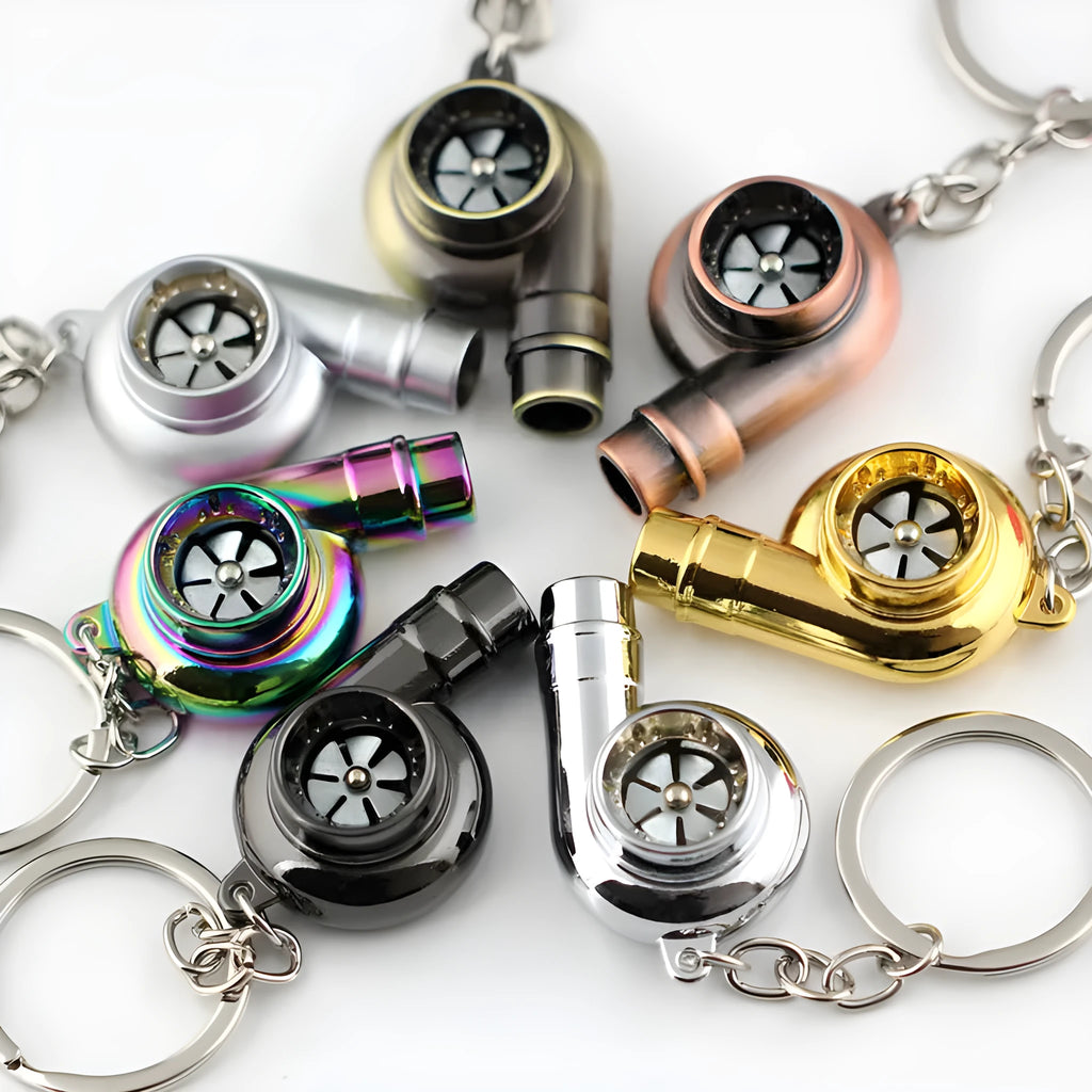 Metal whistle keychain with keyring in gold colour, front view on white background
