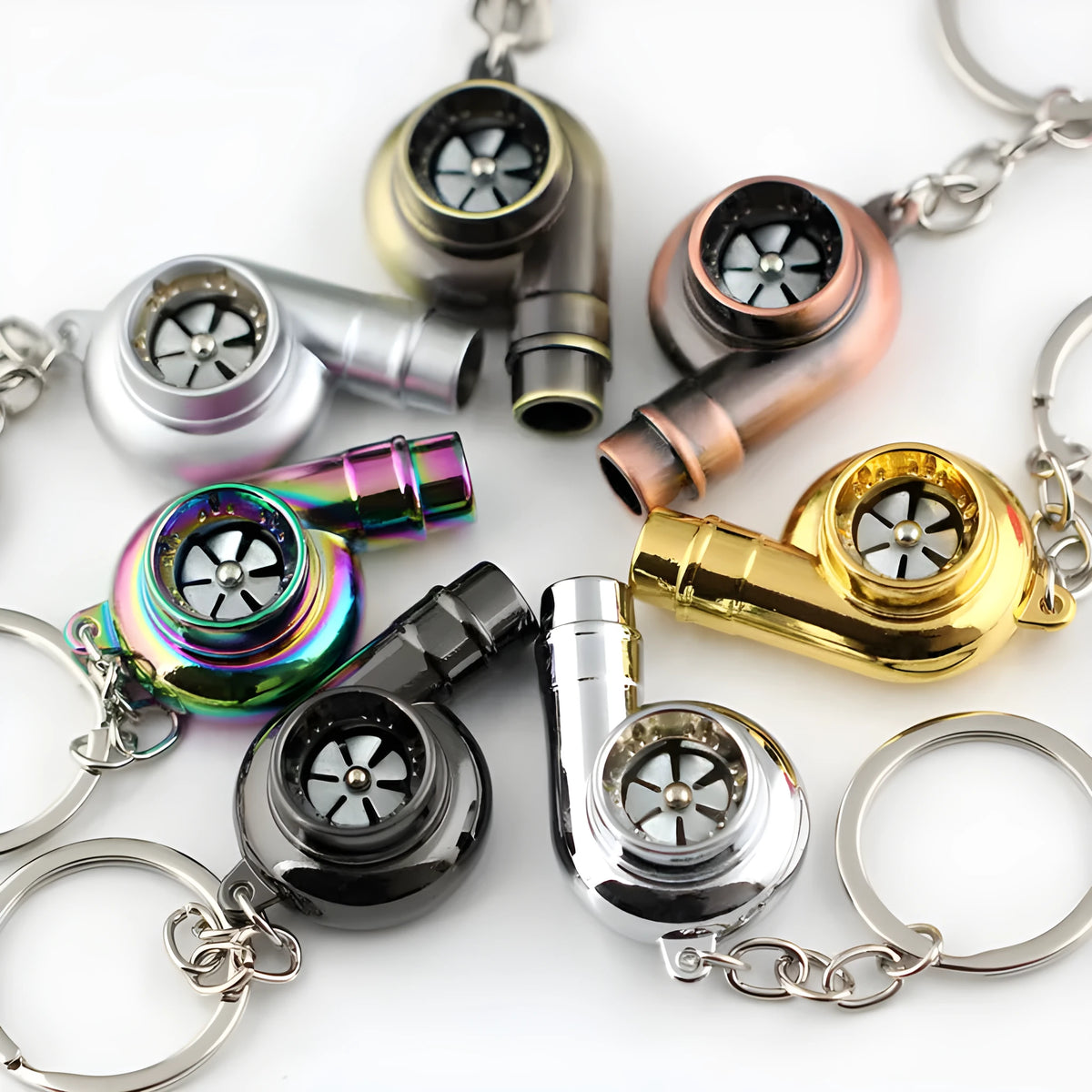 Metal whistle keychain with keyring in gold colour, front view on white background