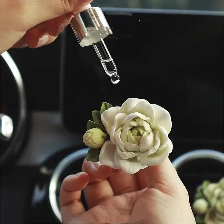 Jasmine-scented gypsum car air freshener ornament in off white or green, shown next to a 5ml essential oil bottle.