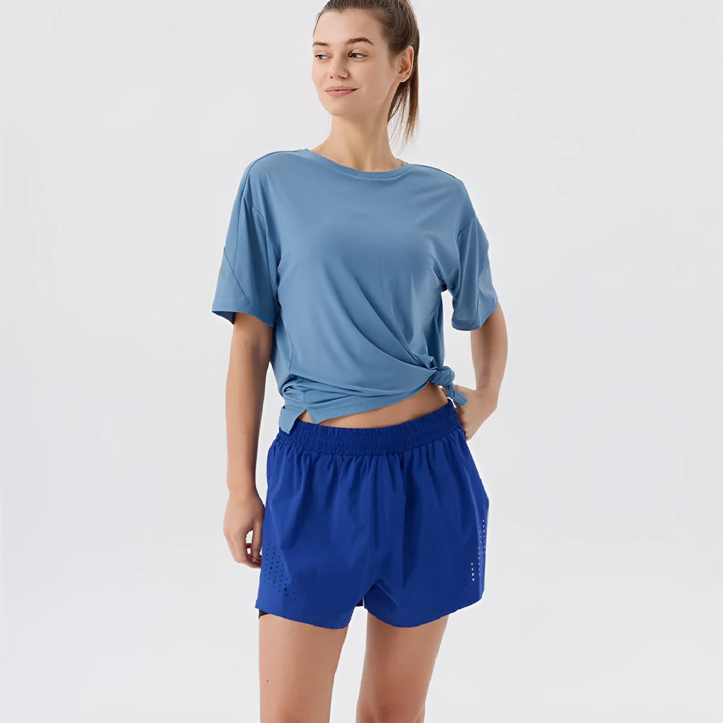 Man wearing black side-slit nylon sports shorts on a casual summer day.