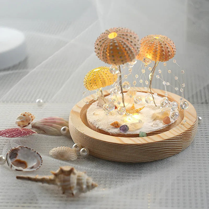 Handmade sea urchin shell jellyfish lamp inside a cylindrical clear glass cover, creative night light with built-in battery