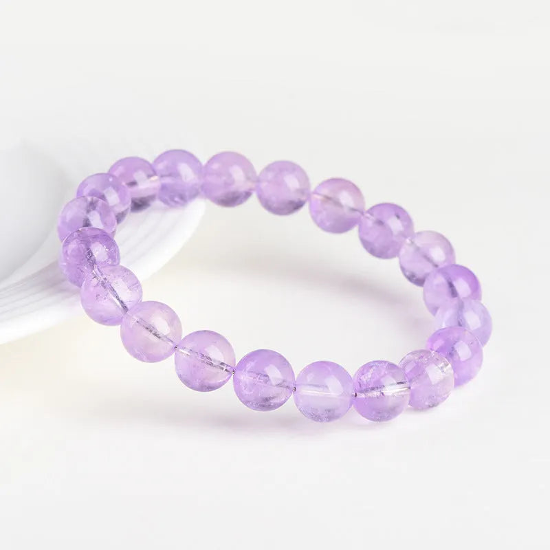 Lavender round amethyst bead bracelet with water ripple texture on a light background.