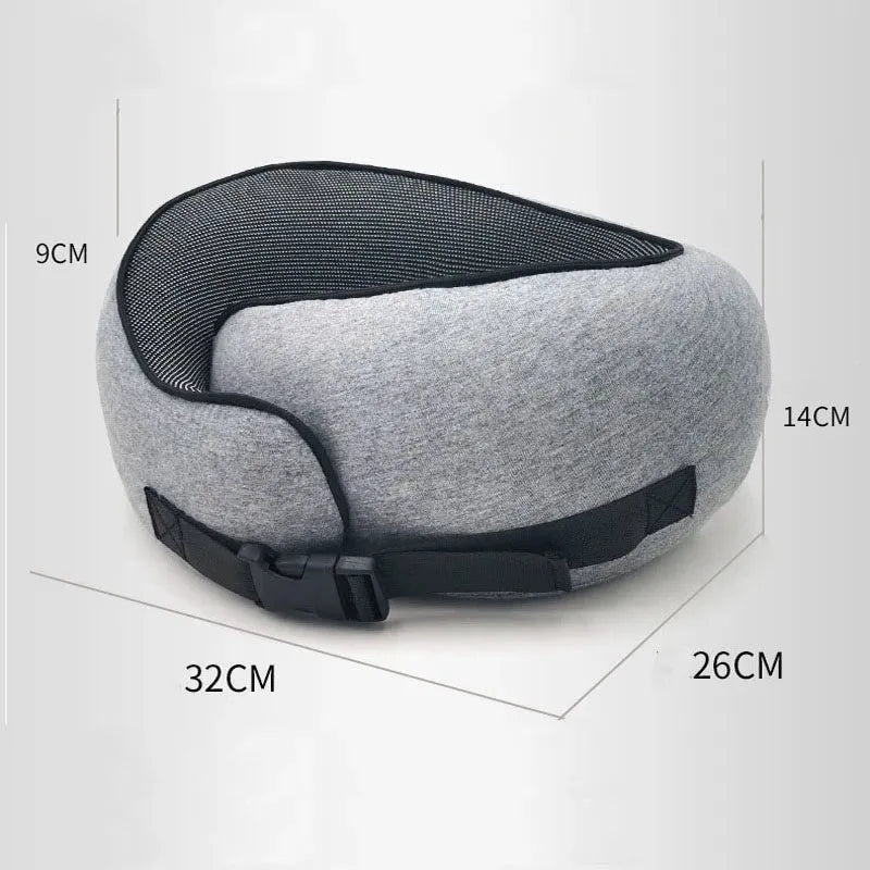 Navy blue U-shaped travel neck pillow with memory foam, shown rolled up next to its carry bag.