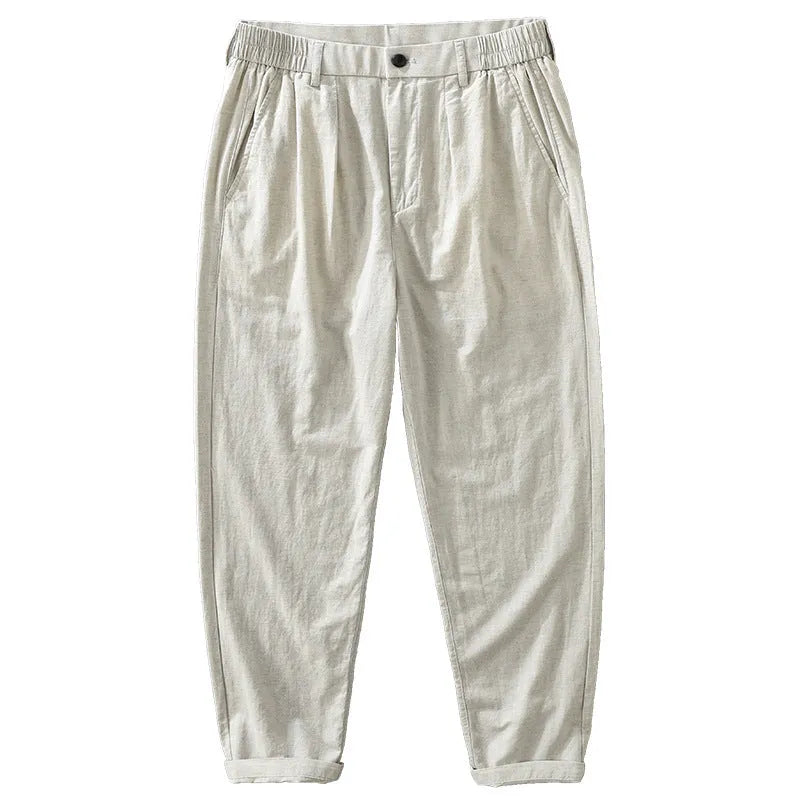 Man wearing loose straight-leg cotton linen trousers in a brown colour, showcasing the retro Japanese style.