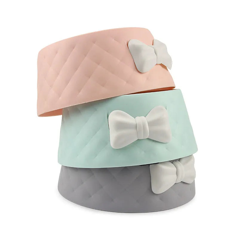 Bow shaped pet feeding bowl in PP plastic available in pink, green, and grey