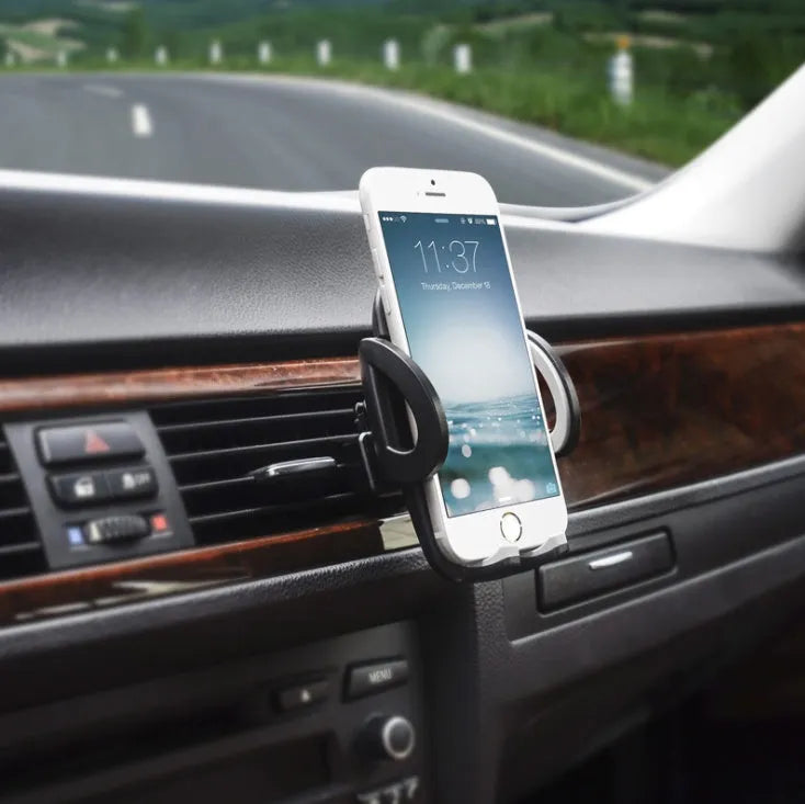Black plastic universal mobile phone holder mounted on car air vent