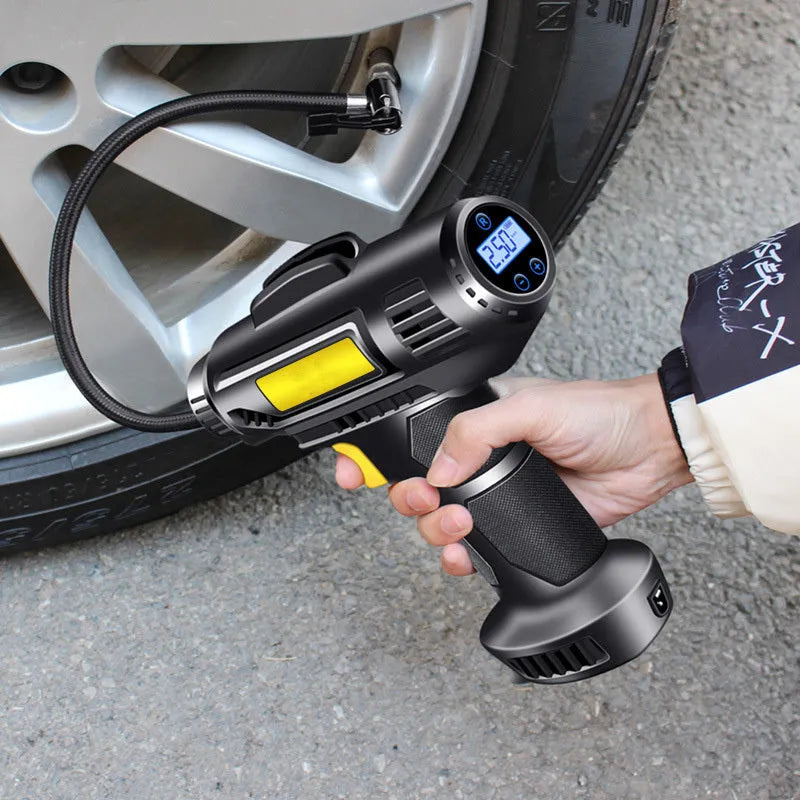 Black wireless digital display car tire air pump with USB charging cable and three nozzles on a grey background.