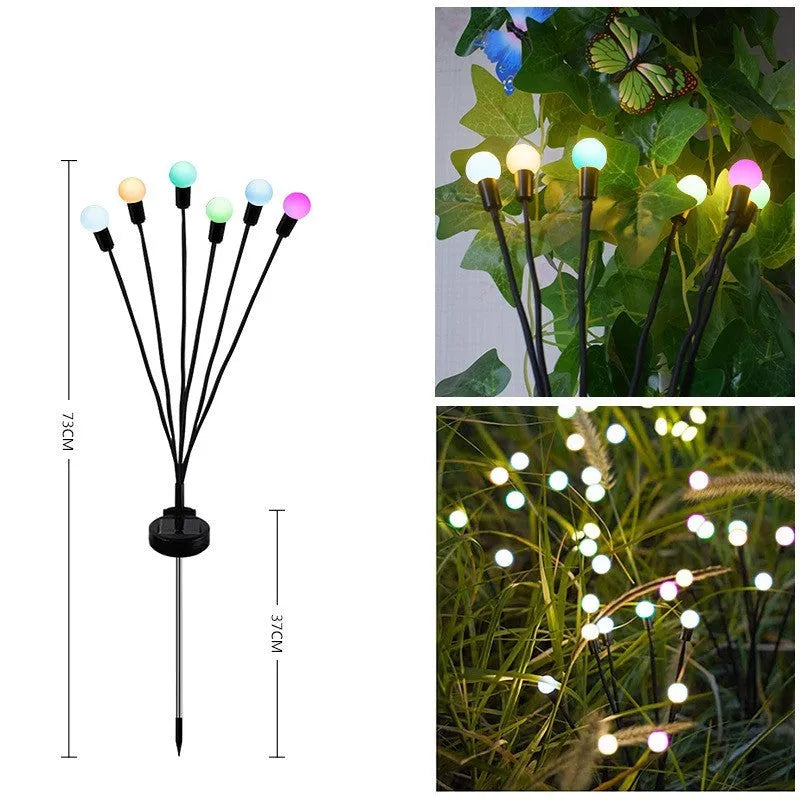 Solar-powered LED pneumatic firefly ground stake light with multiple heads on a grassy lawn.