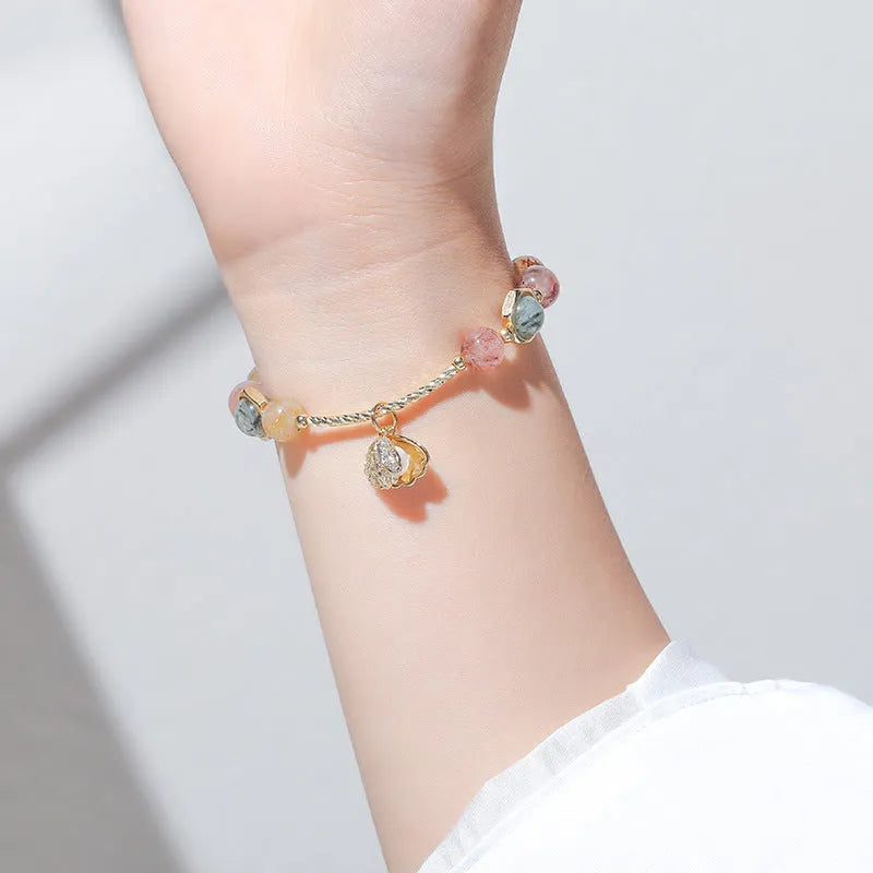 Colourful crystal shell bracelet with hair crystal detailing and red sealant flower shell accents
