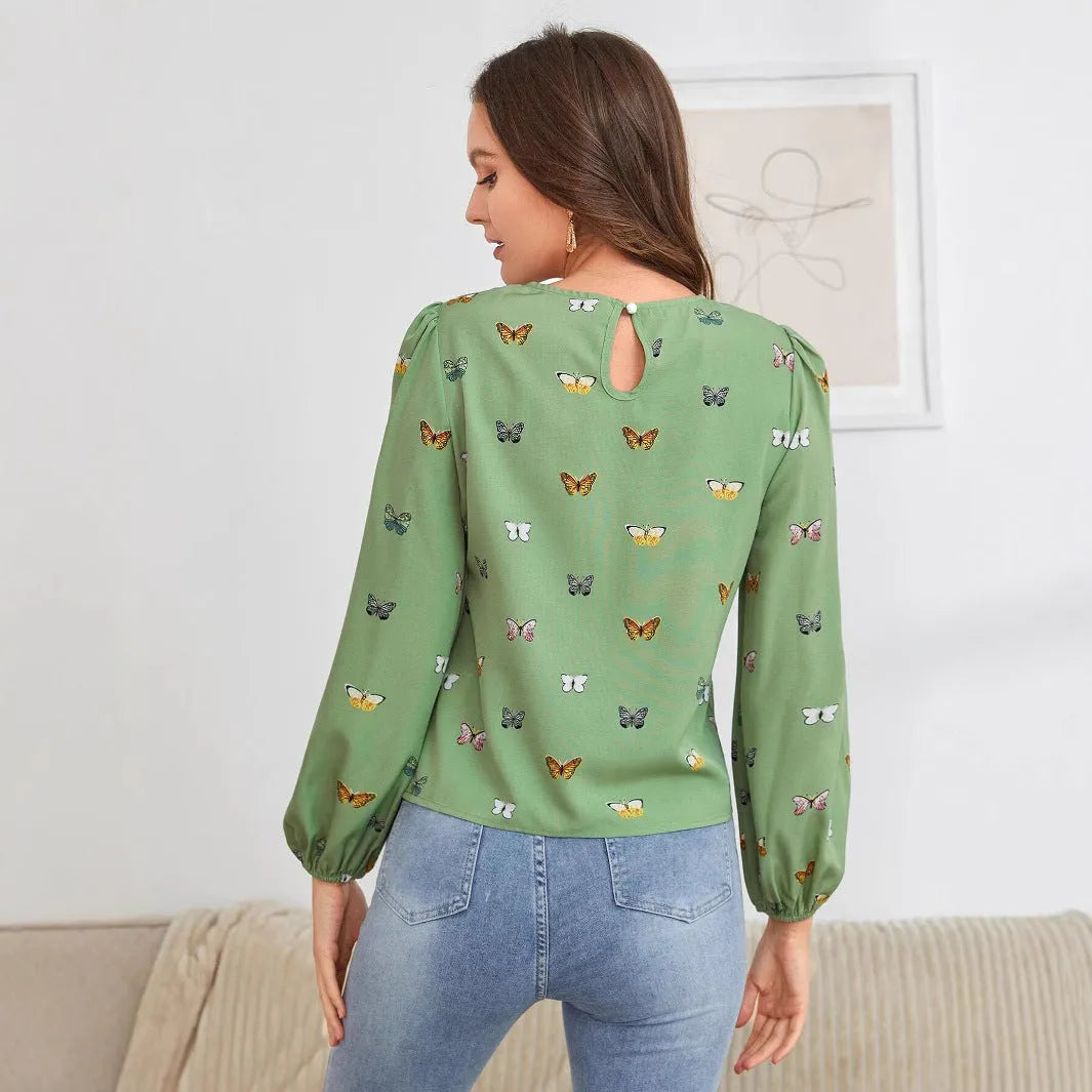 Women's green long-sleeved shirt with butterfly print pattern and loose fit.